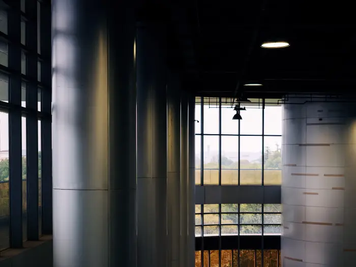 Modern office interior with tall windows and metal columns